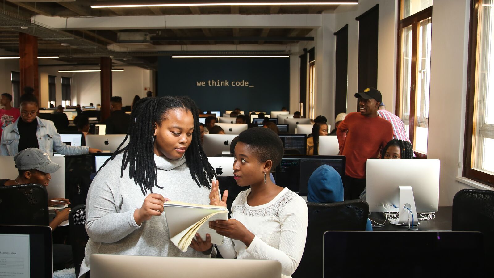 Two young women working together during digital job training in a WeThinkCode classroom