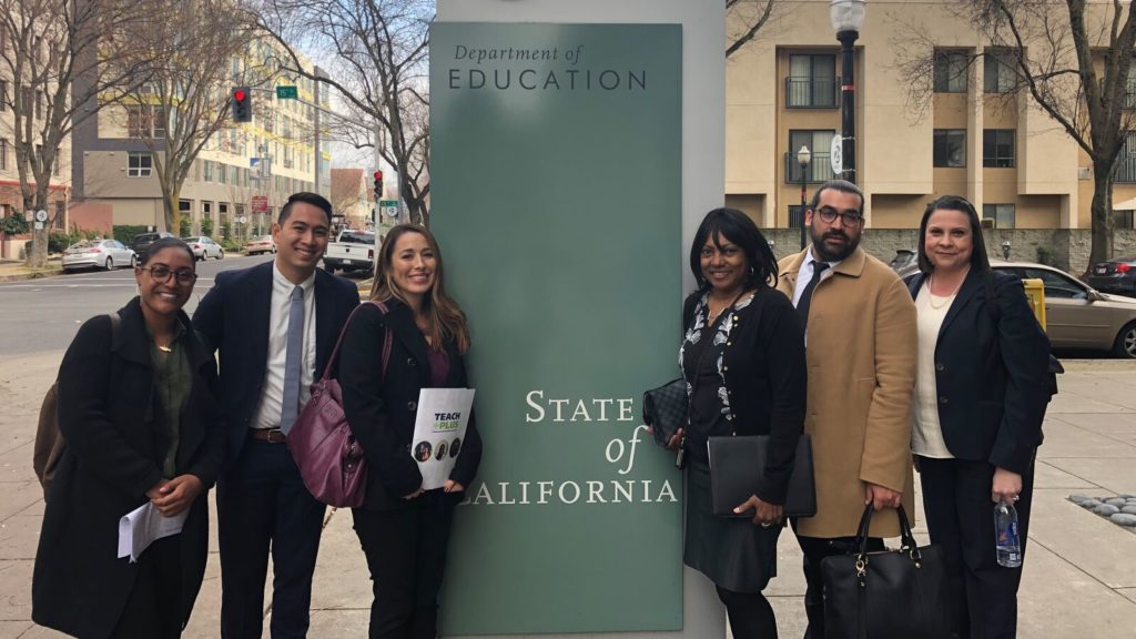 A group of six teachers, two men and four women, posing outside the California Department of Education
