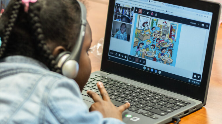 An OnYourMark student reciving one-on-one online, interactive tutoring on her computer, in her classroom.
