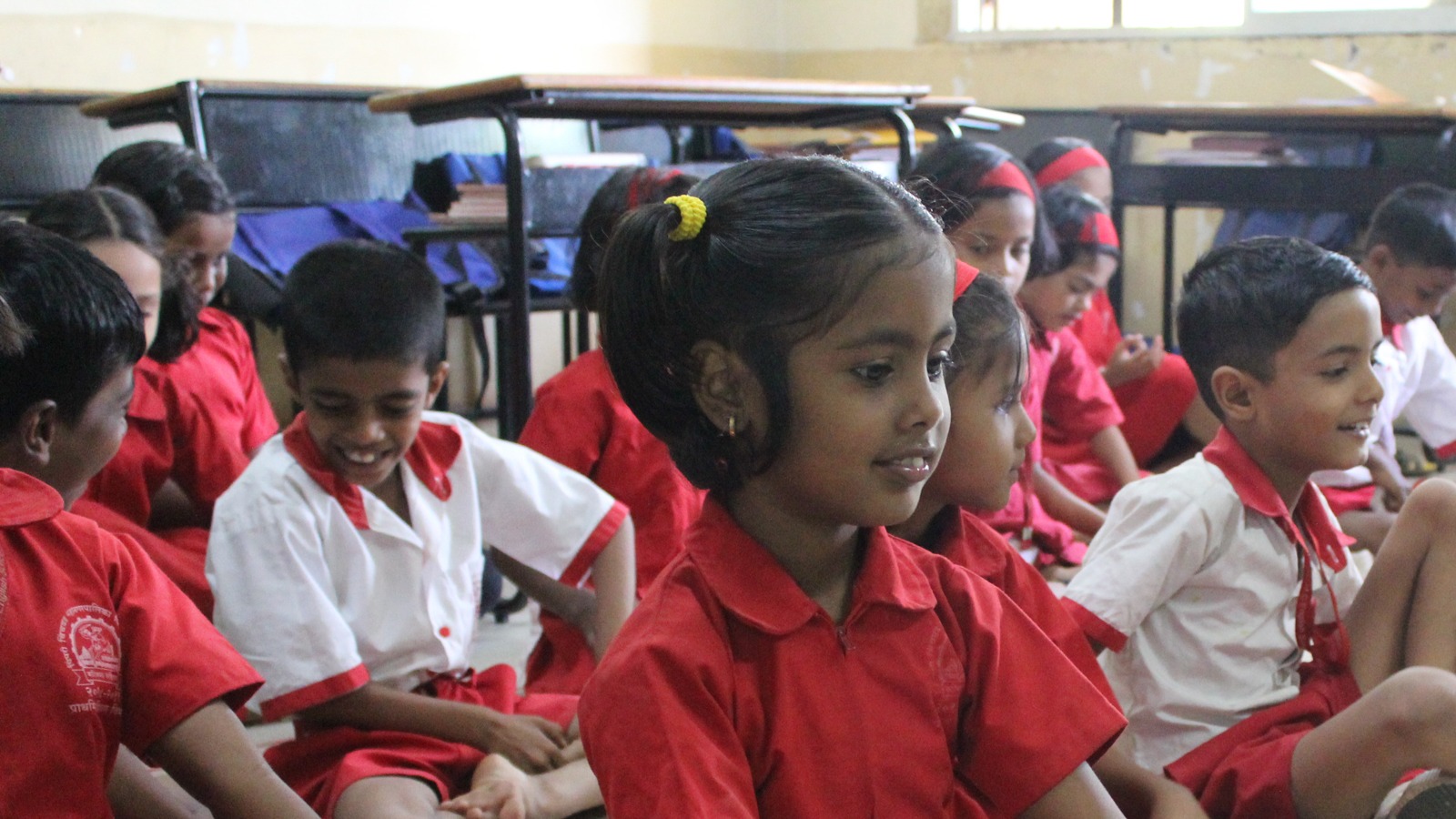 Indian students sit in their classroom learning together.