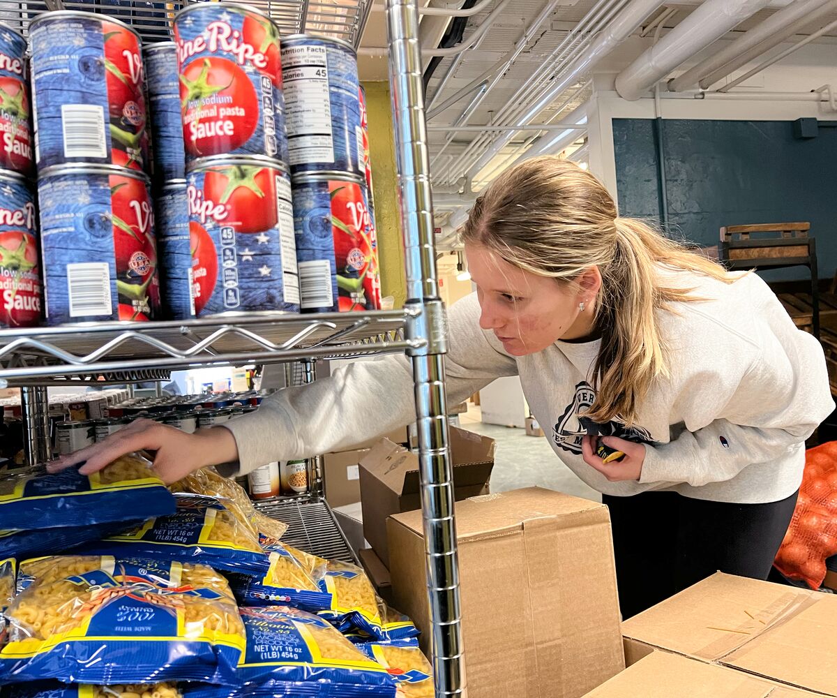 Student volunteers re-stocking the food pantry at the University of Michigan, a Swipe Out Hunger campus partner.