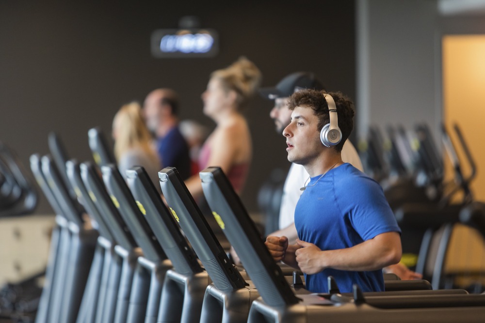 A DJCC member runs on a treadmill.