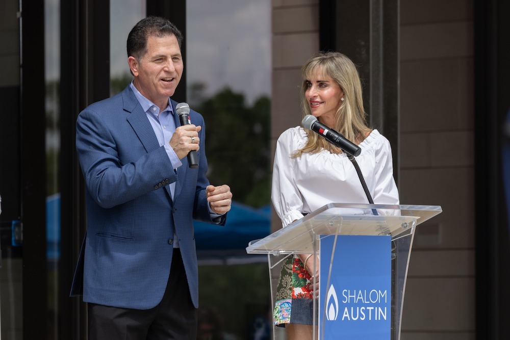 Michael and Susan Dell speaking at an event.