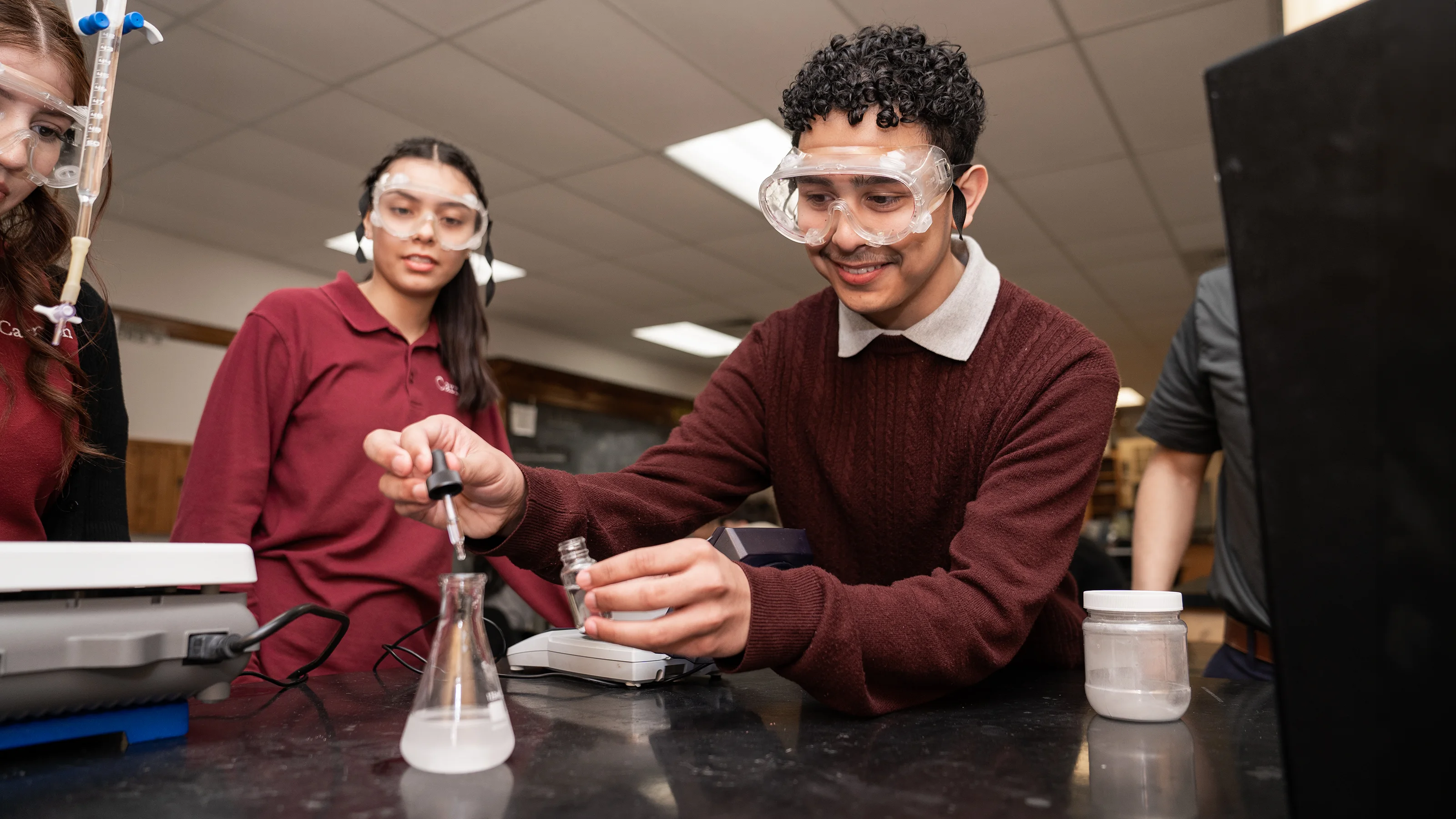 Students work on a science experiment in a classroom lab.