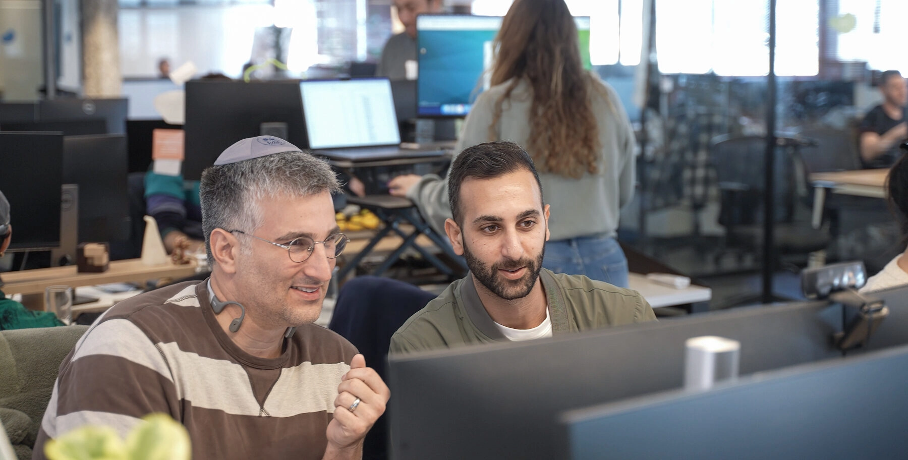 Two Eleos workers at their desk.