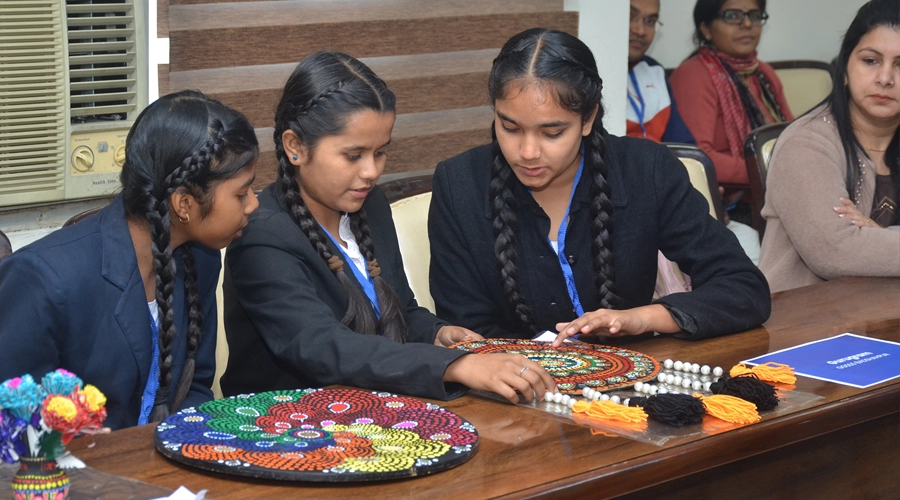 Three students work on a creative project.