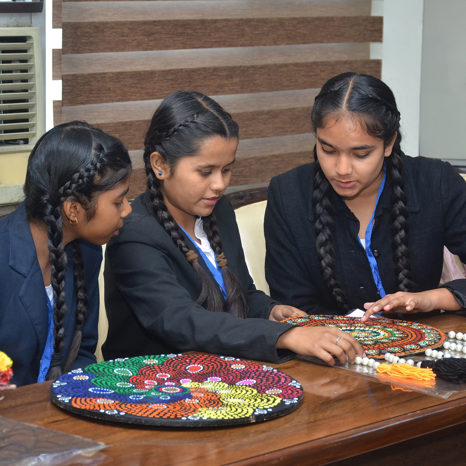 Three students work on a creative project.