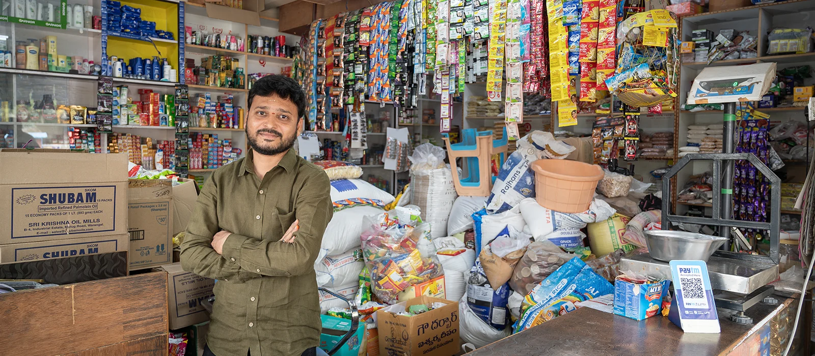 A small business owner stands in his shop.