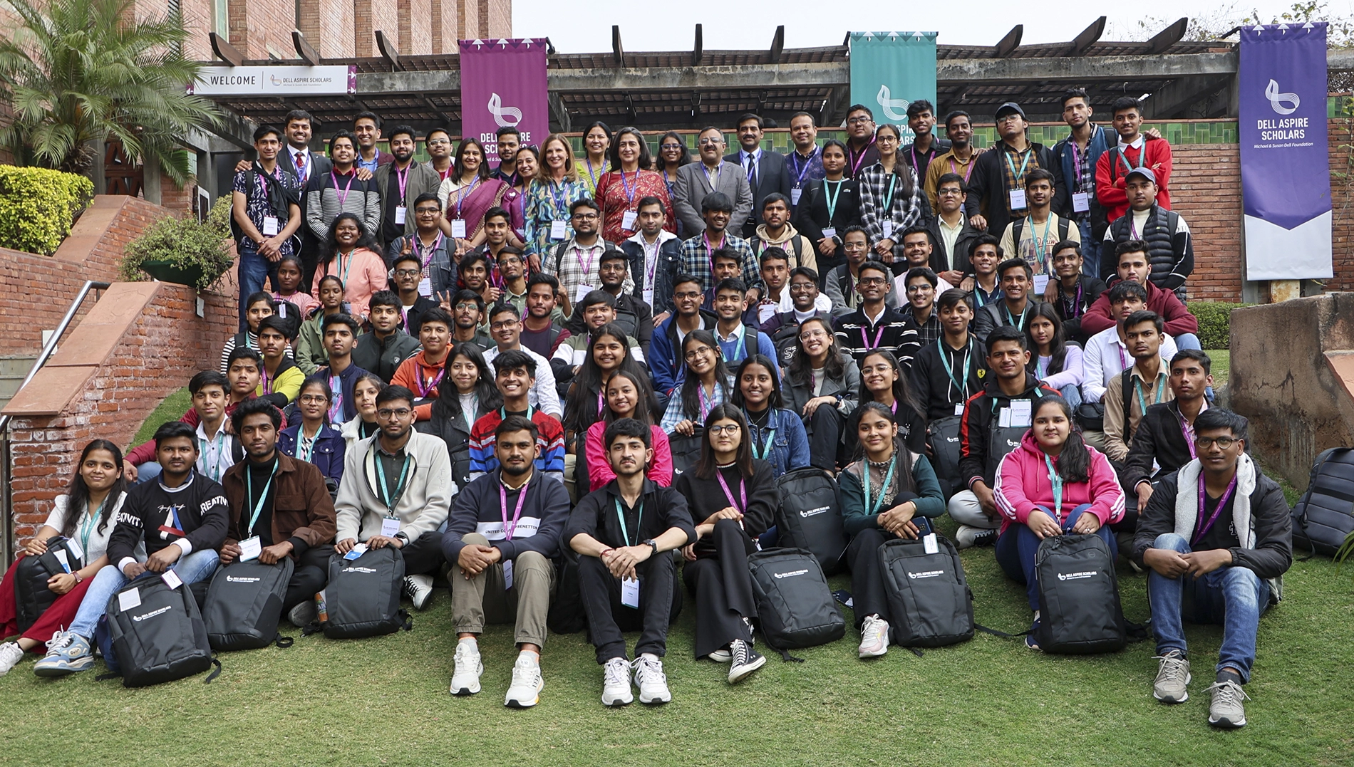 A large group of Dell Aspire Scholars sit on the grass.