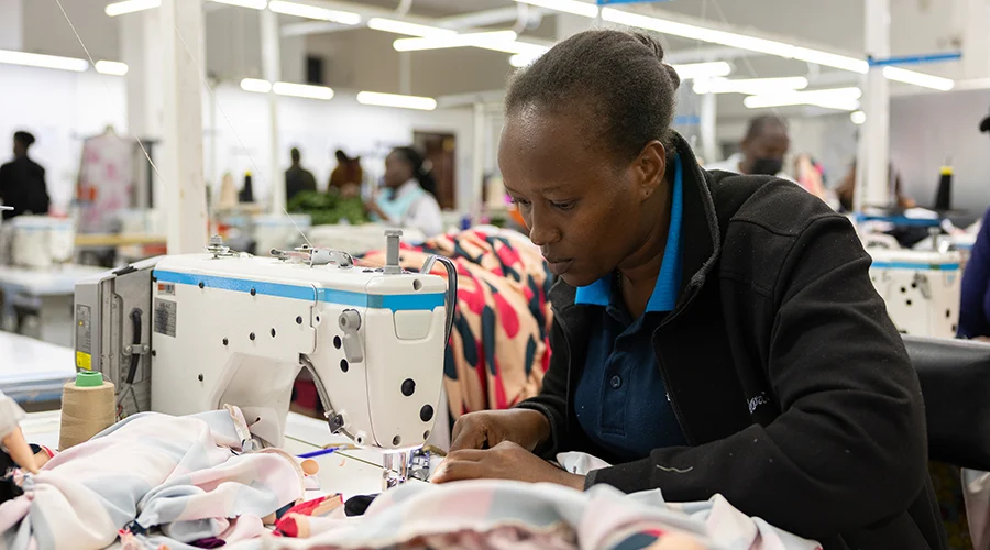 A woman works with a sewing machine.
