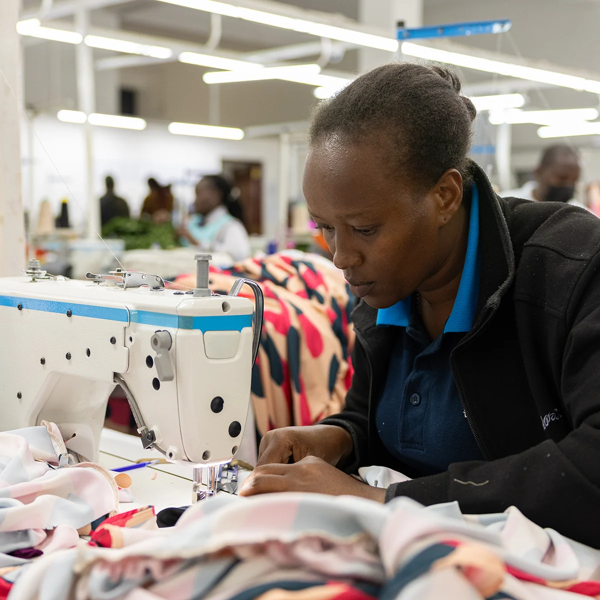 A woman works with a sewing machine.